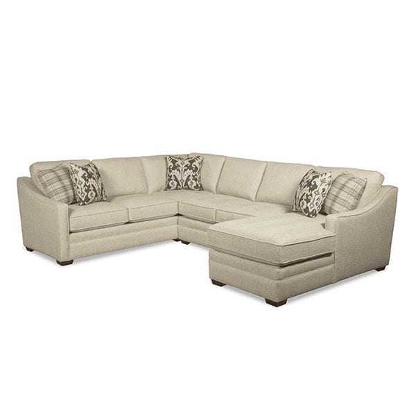 White, upholstered, 6 cushion sectional with curve track arm rests and chaise on right side.