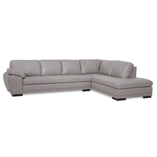 Light grey, leather, 6 cushion, tufted seat sectional with cushioned arms and chaise on right side.