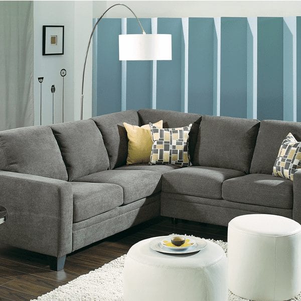 Grey, upholstered, 5 cushion sectional with classic track, squared arm rests.